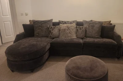 Stylish Modern Grey Sofa with Circular Ottoman and Cushions