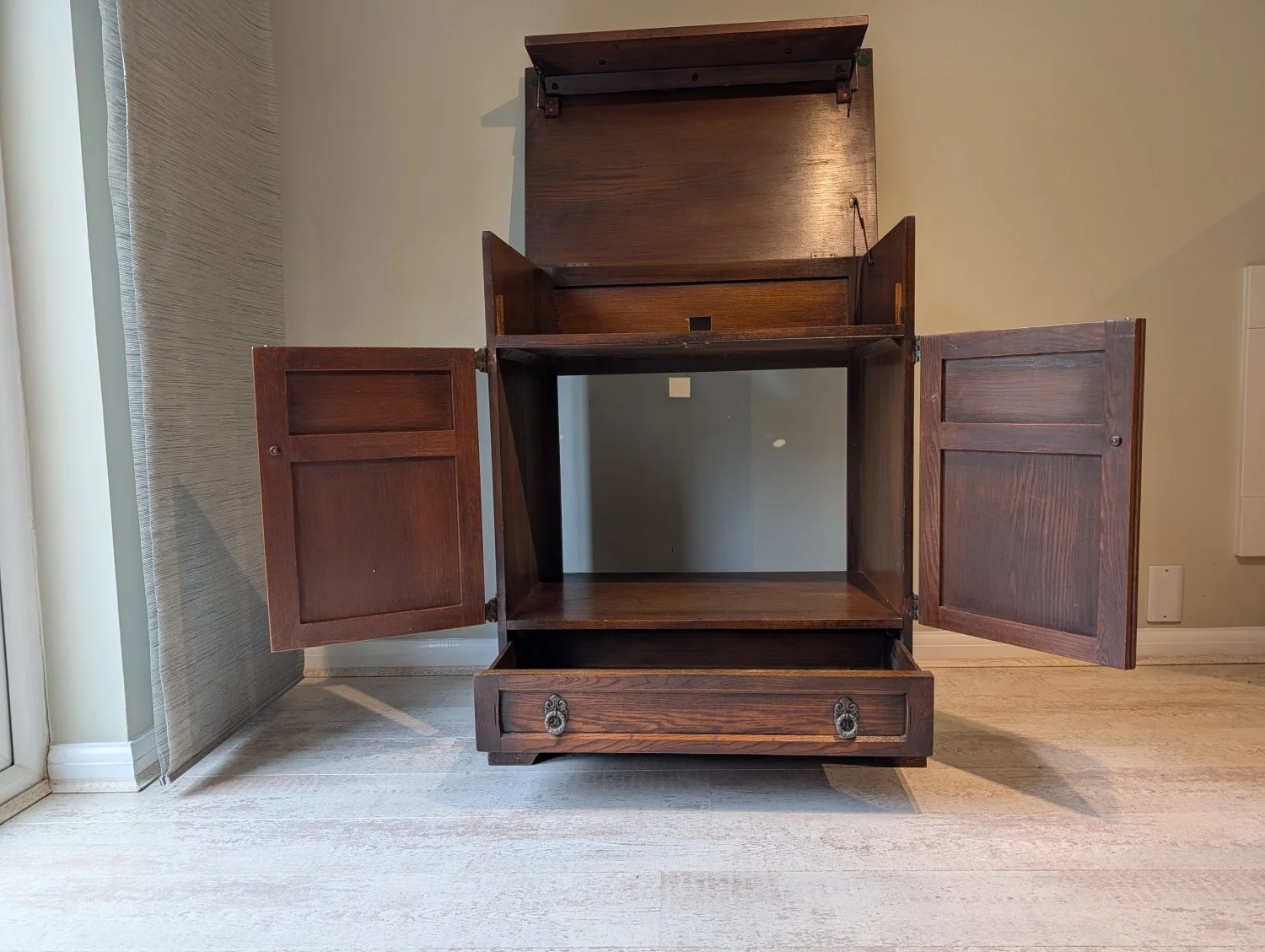 Vintage Wooden Cabinet with Drop-Down Top and Intricate Hardware