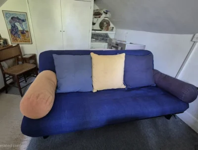 Blue futon sofabed with cushions