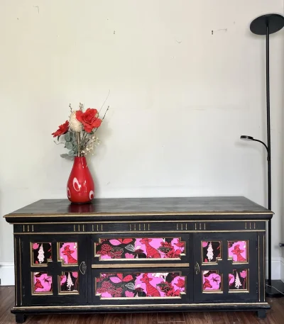 Vintage black storage cabinet with decorative panels