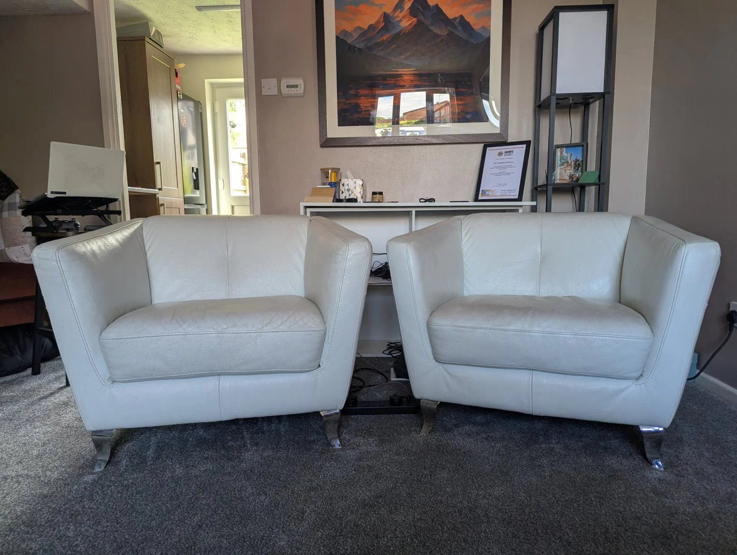 Pair of modern white leather armchairs with chrome legs