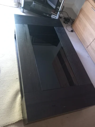 Large black rectangular coffee table with glass inset
