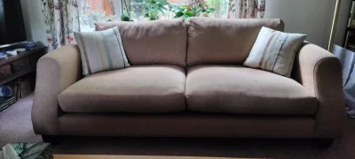 Modern two-seater sofa in warm taupe woven fabric with scatter cushions