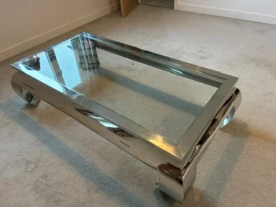 Large rectangular glass coffee table with polished metal frame