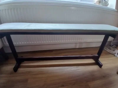 Vintage dark wood piano bench with pale upholstered seat