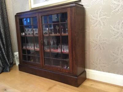 Vintage dark wood glazed display cabinet with leaded-style doors